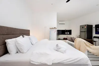 a bedroom with a white bed with white pillows at Casa Bella - Private Studio Ipoh - Pet allowed in Ipoh