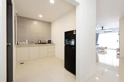 a kitchen with a black refrigerator in a room at Arctic Breeze - Pengkalan WaterPark Pool Gym in Ipoh