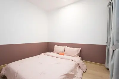 a small bedroom with a bed with an orange object on it at Arctic Breeze - Pengkalan WaterPark Pool Gym in Ipoh