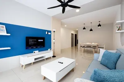 a living room with a blue accent wall at Arctic Breeze - Pengkalan WaterPark Pool Gym in Ipoh