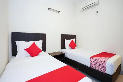 two beds in a room with red and white pillows at Dancenter Near Petronas Kampung Koh, Jj Hotel in Kampung Koh