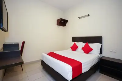 a hotel room with a bed with red pillows at Dancenter Near Petronas Kampung Koh, Jj Hotel in Kampung Koh