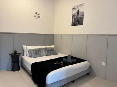 a bedroom with a bed with a black and white at Ipoh Modern Family Retreat in Ipoh