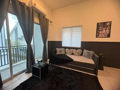 a bedroom with a bed and a large window at Ipoh Modern Family Retreat in Ipoh
