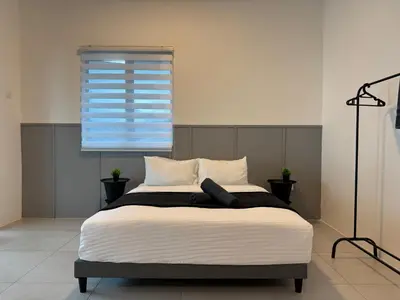 a bedroom with a large bed with a window at Ipoh Modern Family Retreat in Ipoh