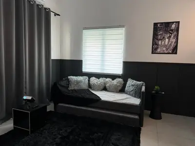 a room with a bed with pillows and a window at Ipoh Modern Family Retreat in Ipoh