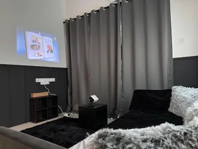 a bedroom with a bed and a curtain at Ipoh Modern Family Retreat in Ipoh