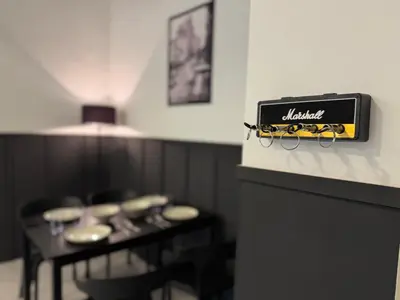 a restaurant with a table with glasses on the wall at Ipoh Modern Family Retreat in Ipoh