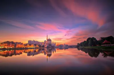 a view of a city at sunset from a river at Klang Prima Bayu Apartment, Taman Bayu Perdana, 42000 Klang in Gua Sai