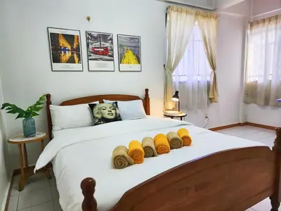 a bedroom with a large bed with yellow knitted blankets at Klang Prima Bayu Apartment, Taman Bayu Perdana, 42000 Klang in Gua Sai