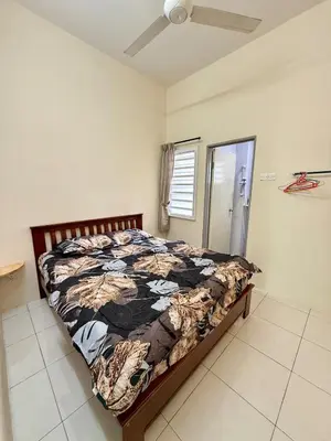 a bedroom with a bed and a ceiling fan at AzzaleaHomes 7 Cameron Highlands in Brinchang
