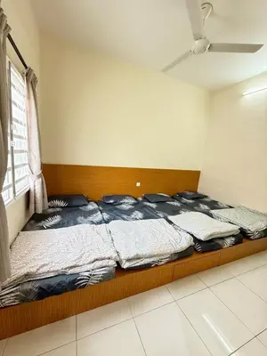 a bed sitting in a room with a window at AzzaleaHomes 7 Cameron Highlands in Brinchang