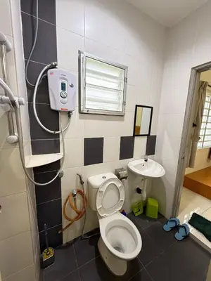 a bathroom with a toilet and a sink at AzzaleaHomes 7 Cameron Highlands in Brinchang