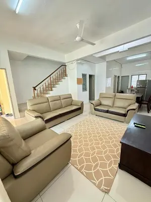 a living room with couches and a couch and a table at AzzaleaHomes 7 Cameron Highlands in Brinchang