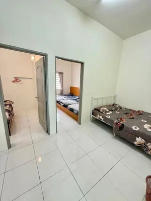 a room with two beds and a hallway at AzzaleaHomes 7 Cameron Highlands in Brinchang