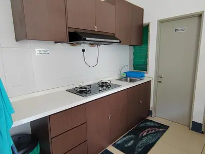 a kitchen with a stove and a sink at Golden hill somersqaure 3 bed room islam apartment in Tanah Rata