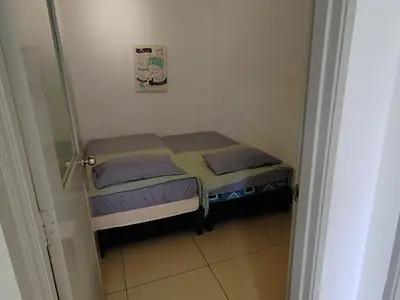 a small bedroom with two beds in a room at Golden hill somersqaure 3 bed room islam apartment in Tanah Rata