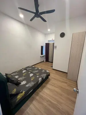 a room with a bed and a ceiling fan at Sbb Star Resources Homestay in Sungai Petani