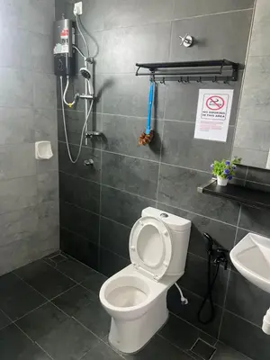 a bathroom with a toilet and a shower and a sink at Sbb Star Resources Homestay in Sungai Petani