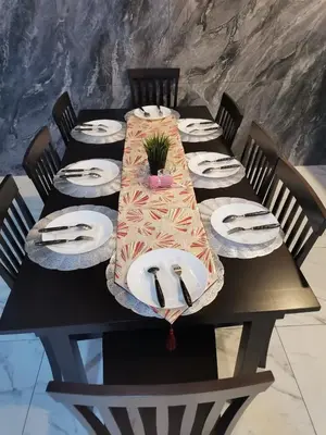 a black table with white plates and a plant on it at Sbb Star Resources Homestay in Sungai Petani