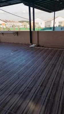 an empty tennis court with a wooden floor at Sbb Star Resources Homestay in Sungai Petani