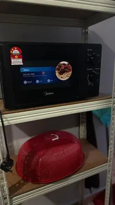 a microwave oven on a shelf with a red hat at Mk homestay butterworth in Butterworth