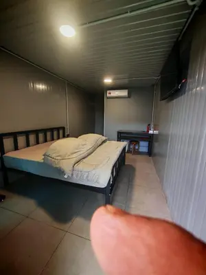 a room with a bed and a table in it at deLotus Villa in Simpang