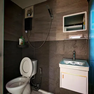 a bathroom with a toilet and a sink at deLotus Villa in Simpang