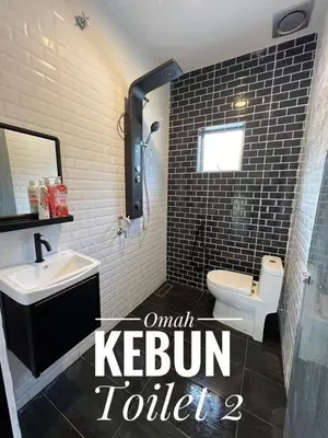 a bathroom with a sink and a toilet at Omah Kebun Private Pool in Sungai Besar