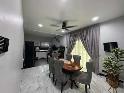 a dining room table and chairs in a living room at Omah Kebun Private Pool in Sungai Besar