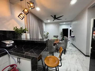 a kitchen and dining room with a table and chairs at Omah Kebun Private Pool in Sungai Besar