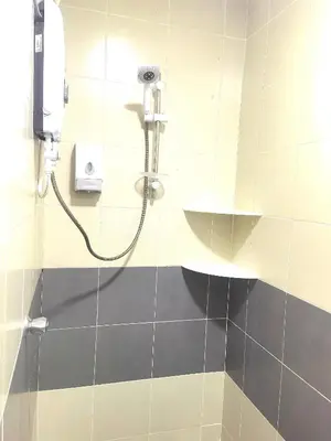 a shower in a bathroom with a shower head at Nice Emerald Avenue suite in Brinchang