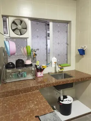 a kitchen counter with a sink and a window at Nice Emerald Avenue suite in Brinchang