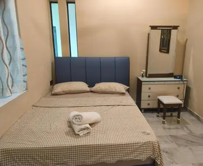 a bedroom with a bed with a mirror and a dresser at Untaian Kaseh Villa at Tambun by S&S Groups Consultant in Ipoh
