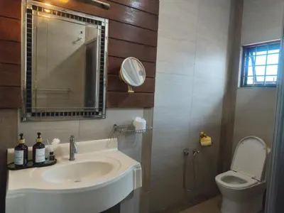 a bathroom with a sink and a toilet and a mirror at Untaian Kaseh Villa at Tambun by S&S Groups Consultant in Ipoh
