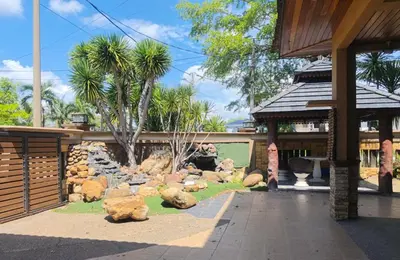 a garden with rocks and palm trees in a building at Untaian Kaseh Villa at Tambun by S&S Groups Consultant in Ipoh