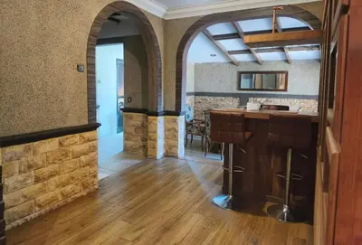 a kitchen with a bar and a dining room at Untaian Kaseh Villa at Tambun by S&S Groups Consultant in Ipoh