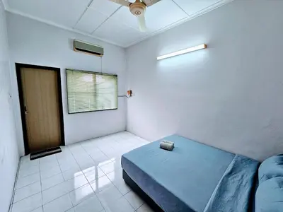 a room with a blue bed and a window at EasyStay Hostel in Ipoh