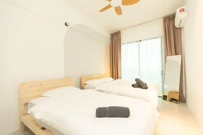 a bedroom with three beds and a window at Meritus Residensi Seaview Pent Hauz 3BR 10Pax in Perai