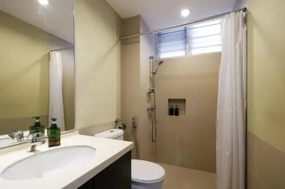 a bathroom with a toilet and a sink and a shower at 3-Bedroom Stay at Macalister Road & Georgetown, Noble Villa Penang in George Town