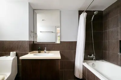 a bathroom with a sink and a tub and a mirror at 3-Bedroom Stay at Macalister Road & Georgetown, Noble Villa Penang in George Town