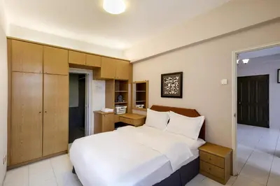 a bedroom with a large white bed and a desk at 3-Bedroom Stay at Macalister Road & Georgetown, Noble Villa Penang in George Town