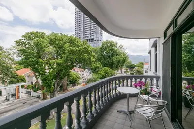 a balcony with a table and chairs on a balcony at 3-Bedroom Stay at Macalister Road & Georgetown, Noble Villa Penang in George Town