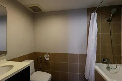 a bathroom with a toilet and a sink and a shower at 3-Bedroom Stay at Macalister Road & Georgetown, Noble Villa Penang in George Town