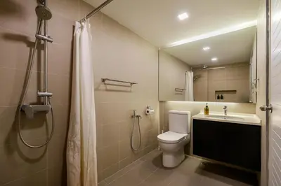 a bathroom with a toilet and a sink and a shower at 3-Bedroom Stay at Macalister Road & Georgetown, Noble Villa Penang in George Town