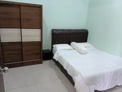 a bedroom with a bed with a black headboard at Rsstay Villa in Lunas