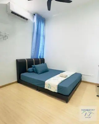 a bed in a room with a blue bed frame at Homestay AZ Kulim in Kulim