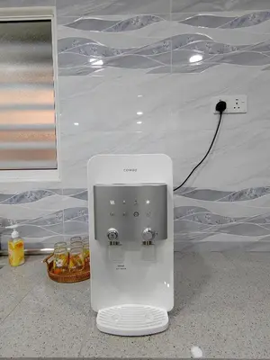 a white appliance sitting on the floor next to a wall at Ipoh Garden Sunway Guesthouse in Ipoh