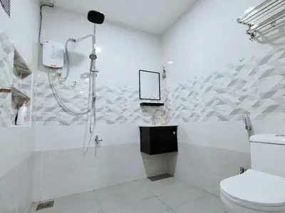a bathroom with a shower and a toilet at Ipoh Garden Sunway Guesthouse in Ipoh