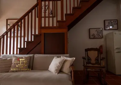 a living room with a couch and a staircase at Lumut Heritage - a walk to Armenian St Art & Cafes in George Town